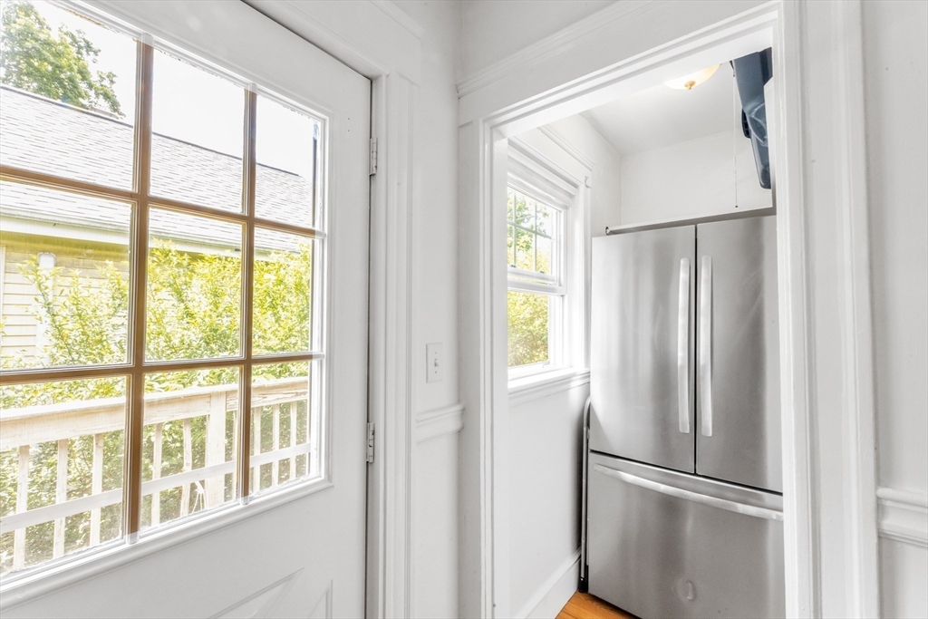 32 Cotuit Street Boston, MA 02132 - Photo 13 of 26 a view of a kitchen with a refrigerator and wooden floor