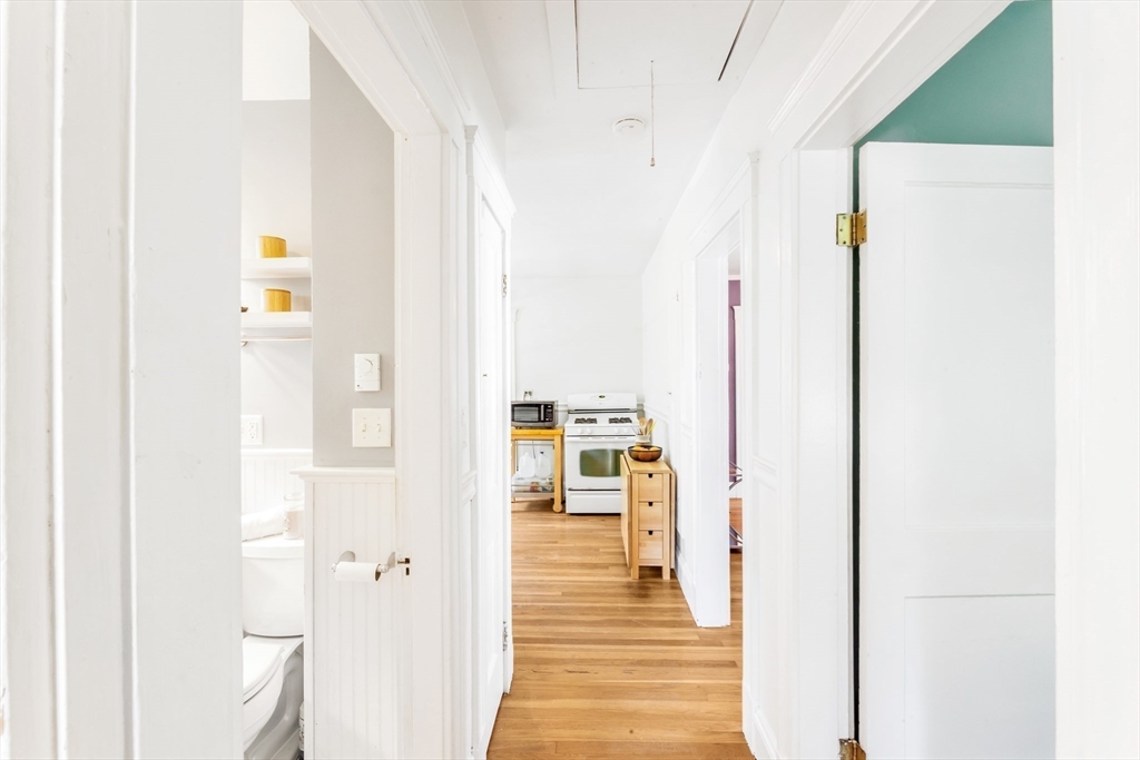 32 Cotuit Street Boston, MA 02132 - Photo 15 of 26 a view of a hallway with wooden floor and staircase
