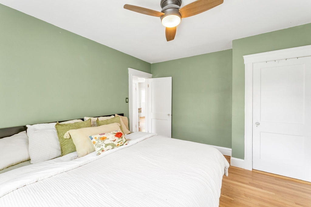 32 Cotuit Street Boston, MA 02132 - Photo 16 of 26 a bedroom with a bed and wooden floor