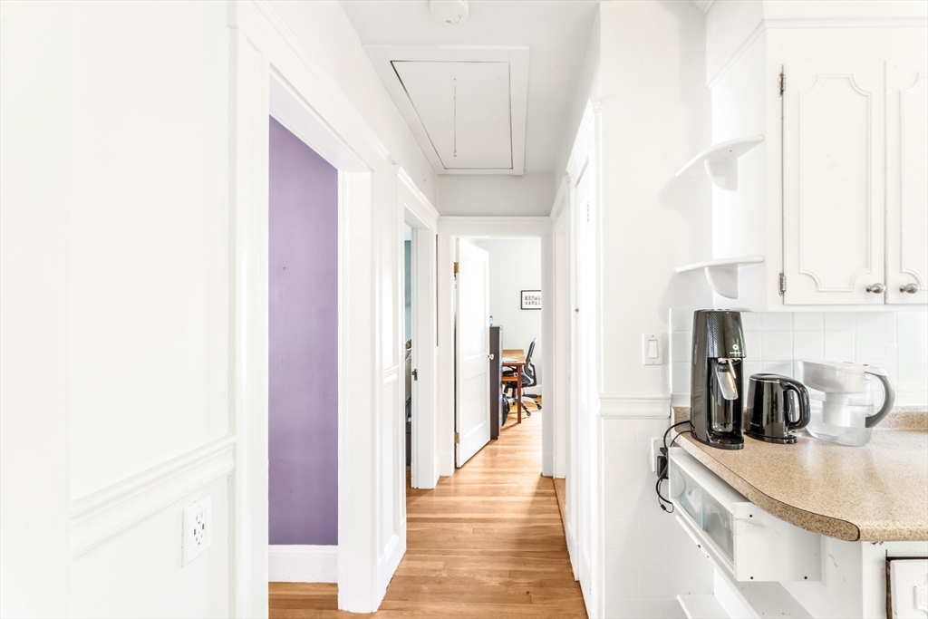 32 Cotuit Street Boston, MA 02132 - Photo 18 of 26 a kitchen with stainless steel appliances granite countertop a sink and a refrigerator