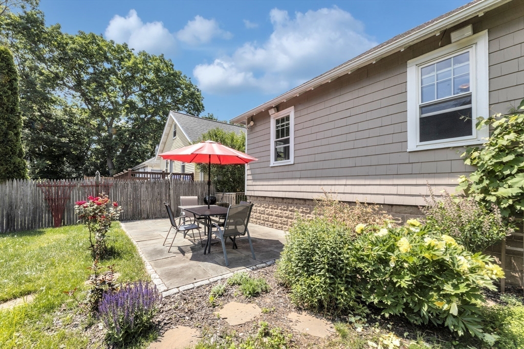 32 Cotuit Street Boston, MA 02132 - Photo 2 of 26 a patio with table and chairs and potted plants