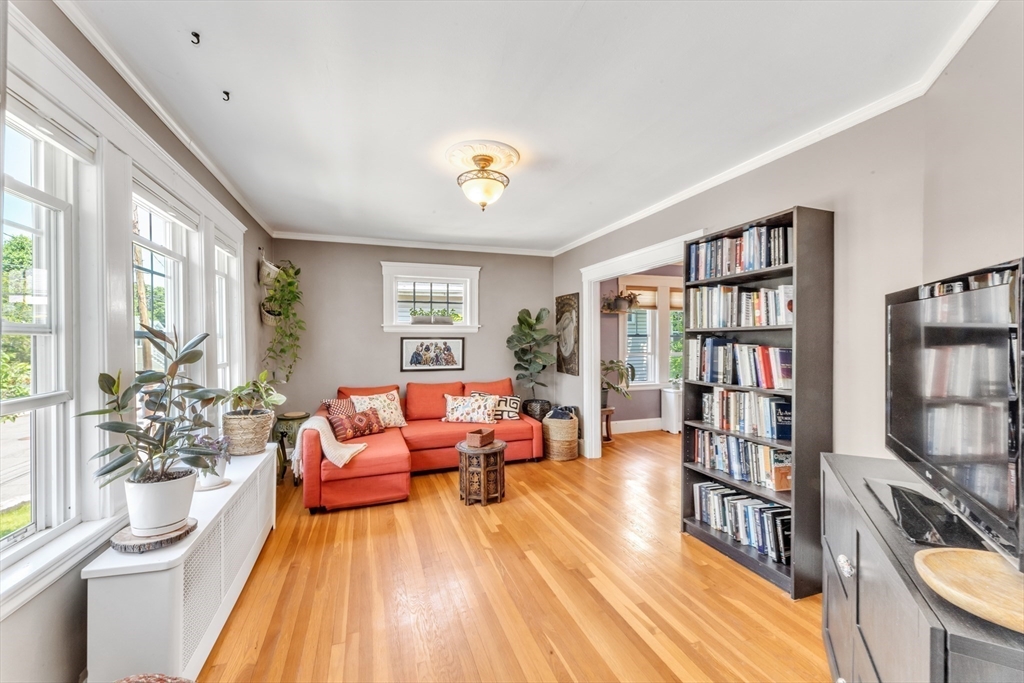 32 Cotuit Street Boston, MA 02132 - Photo 6 of 26 a living room with fireplace furniture and a book shelf