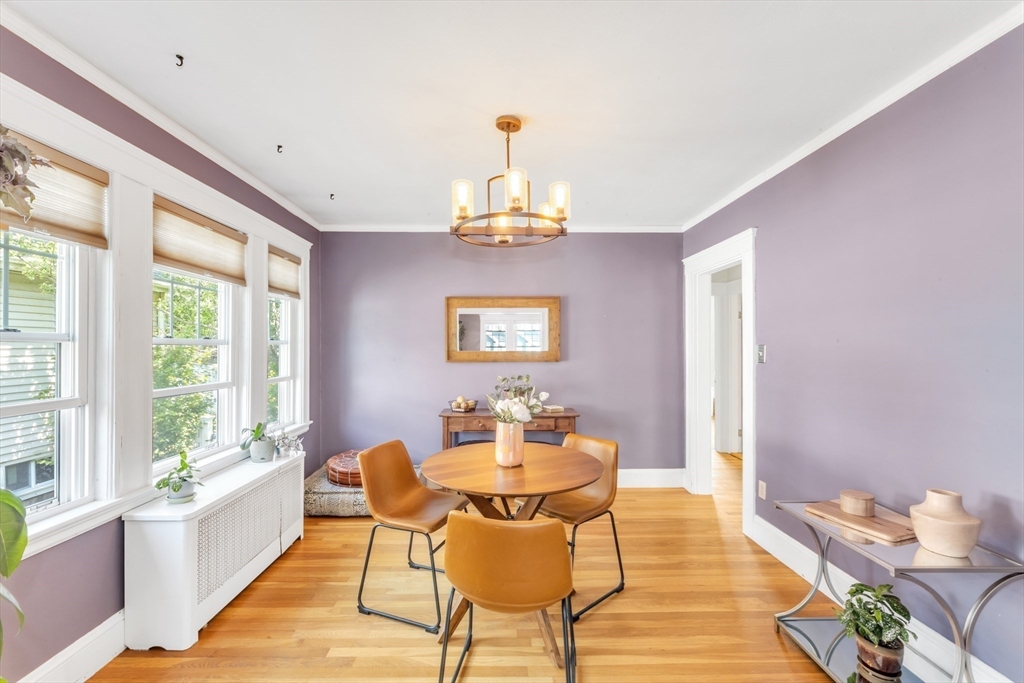 32 Cotuit Street Boston, MA 02132 - Photo 9 of 26 a dining room with wooden floor and chandelier