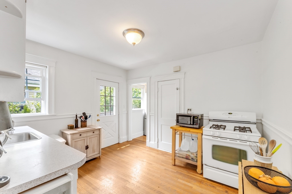 32 Cotuit Street Boston, MA 02132 - Photo 10 of 26 a kitchen with a stove a sink and a refrigerator
