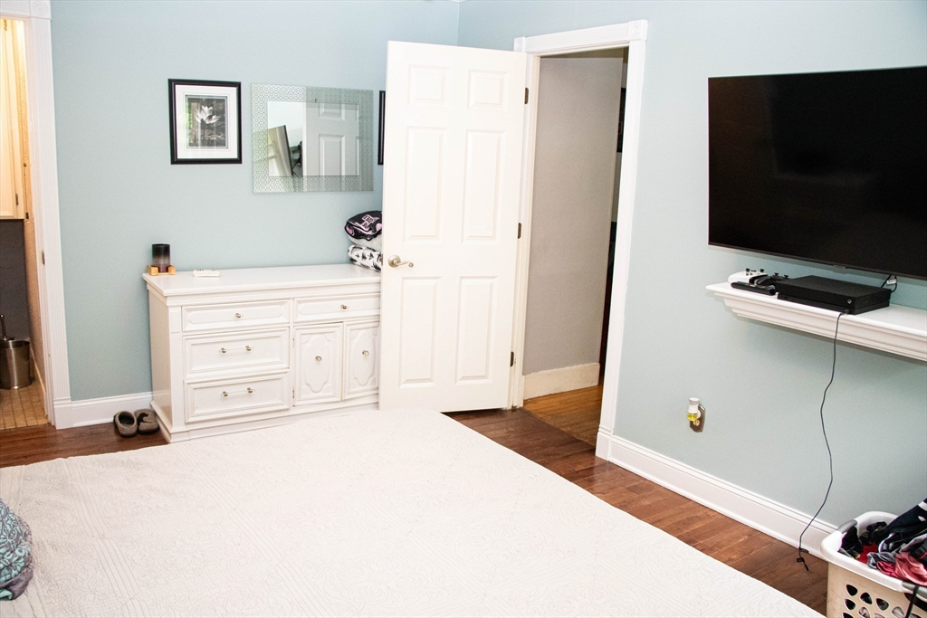 85-87 Slater Street Webster, MA 01570 - Photo 33 of 41 a bedroom with a bed and a flat screen tv