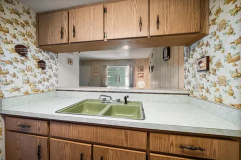 a white refrigerator freezer and a stove sitting inside of a kitchen