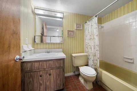 a bathroom with a shower curtain and a toilet