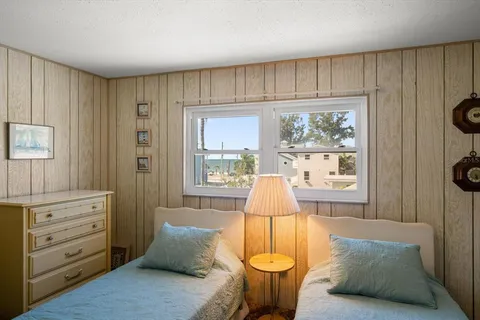 a bedroom with a bed and a window with outer view