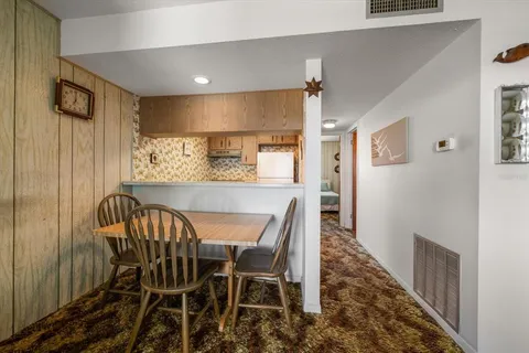a bathroom with a granite countertop sink a toilet and a shower