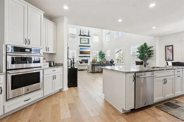 a kitchen with appliances a sink and cabinets