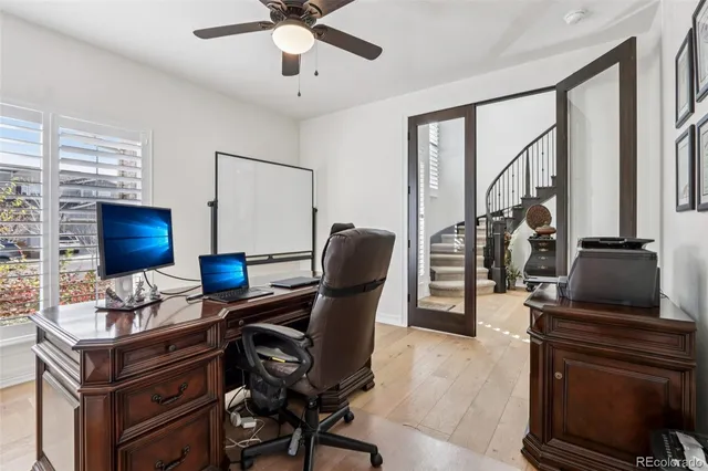 a view of workspace with wooden floor windows
