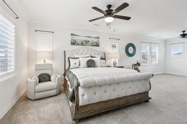 a bedroom with a bed mirror and window
