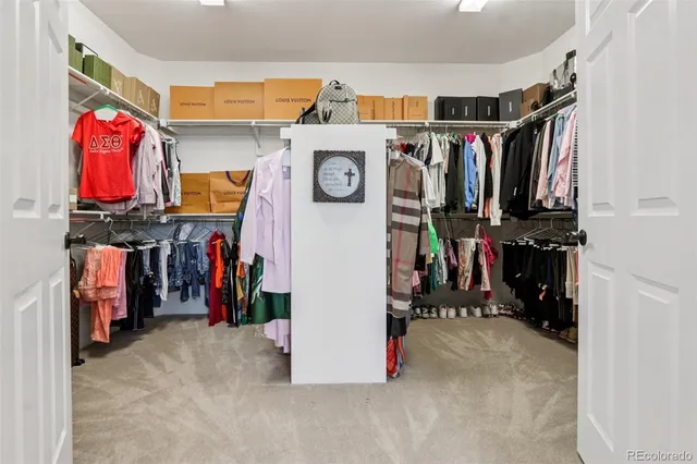 a view of walk in closet with clothes