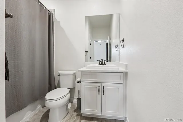 a bathroom with a sink toilet and mirror