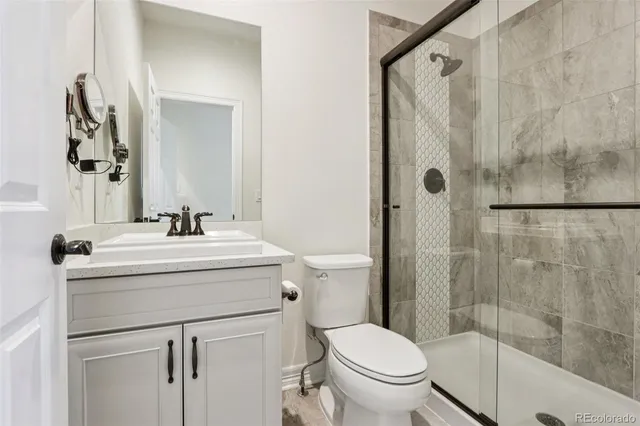 a bathroom with a sink toilet and shower
