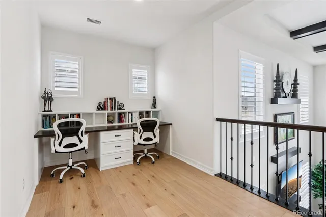 a view of a workspace with furniture and a window