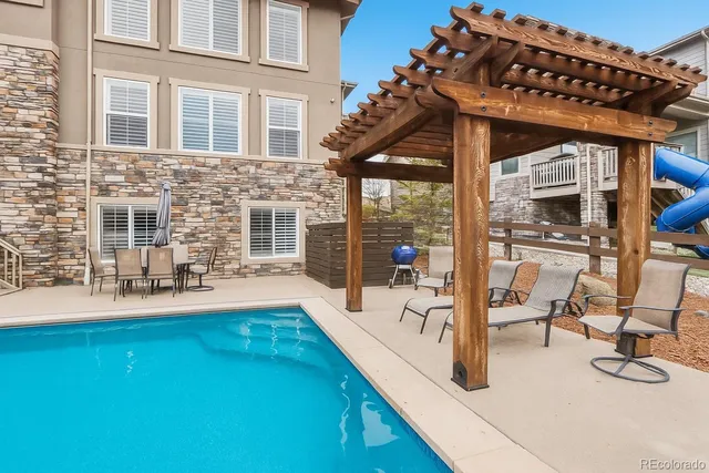 a view of a patio with swimming pool table and chairs