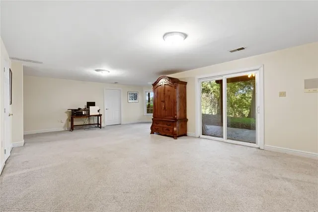 a view of empty room with furniture and a window