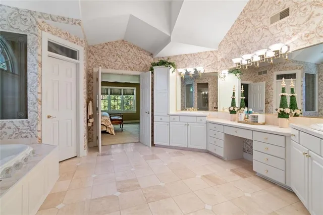 a large bathroom with a large tub sink shower and mirror