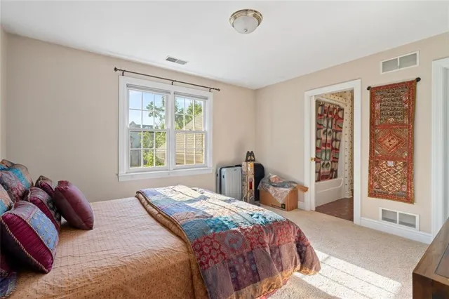 a bedroom with a large bed and a window