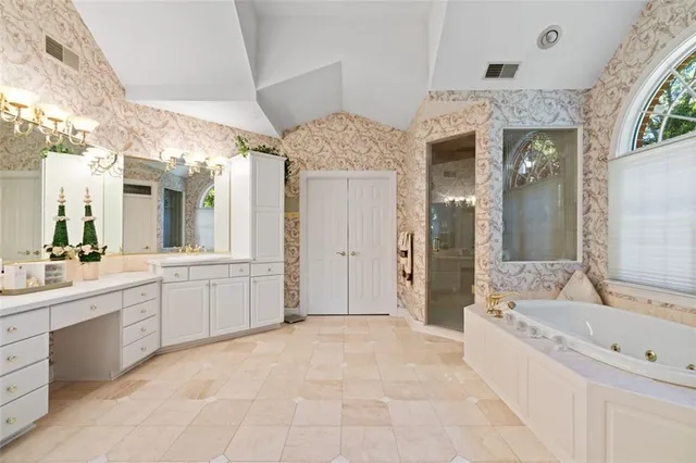 a large spacious bathroom with a granite countertop tub sink shower and mirror