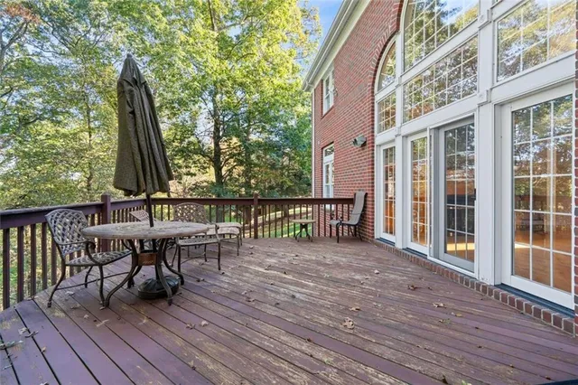 a view of a deck with table and chairs and wooden floor