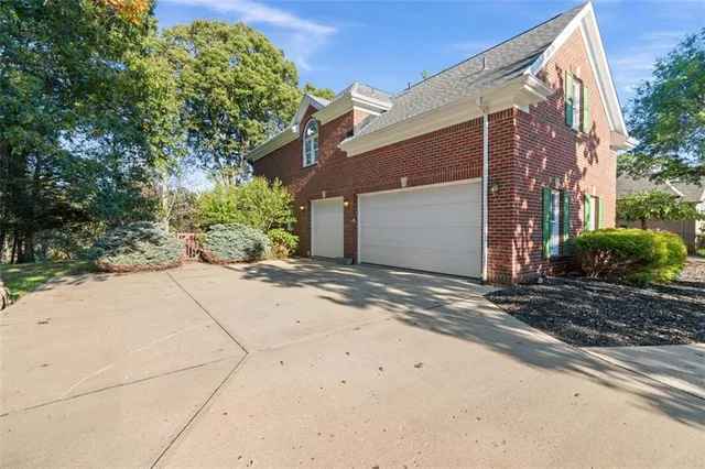 a view of a house with a yard and tree s