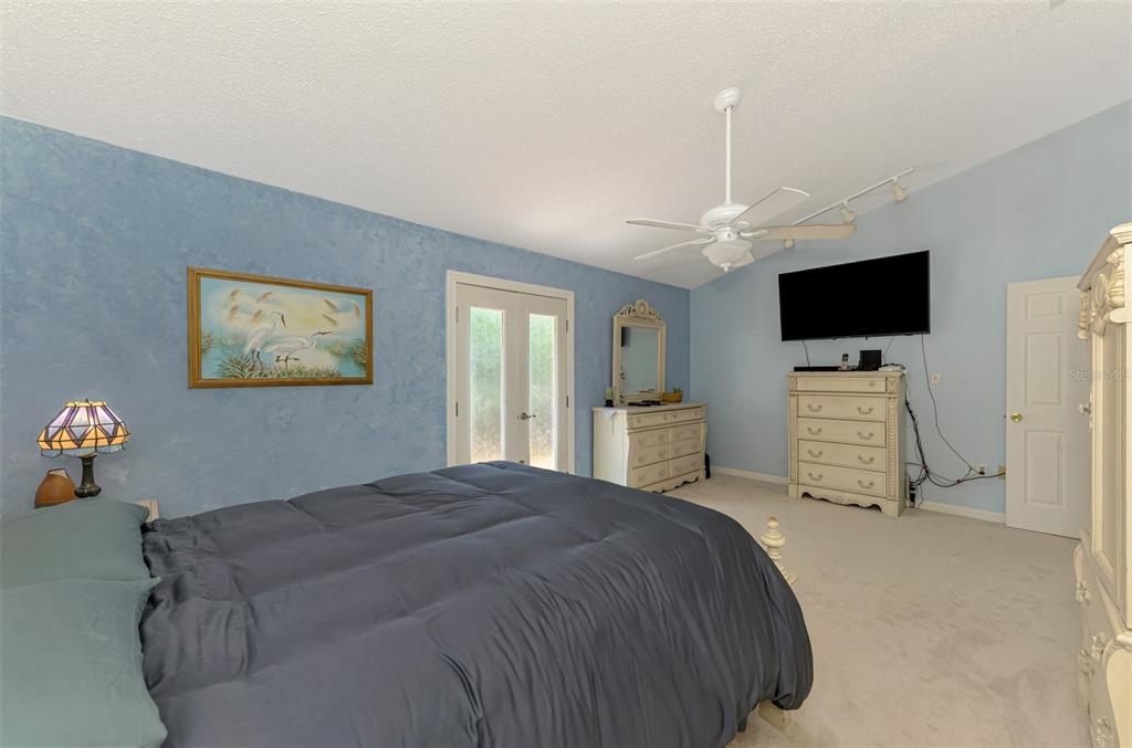 1137 Ponderosa Road Venice, FL 34293 - Photo 25 of 48 a bedroom with a bed and a flat screen tv