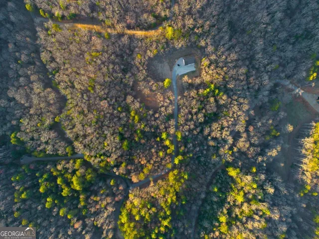 an empty room with wooden floor and window