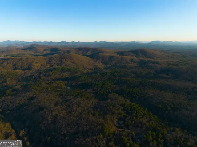 a view of a kitchen with a sink and a refrigerator