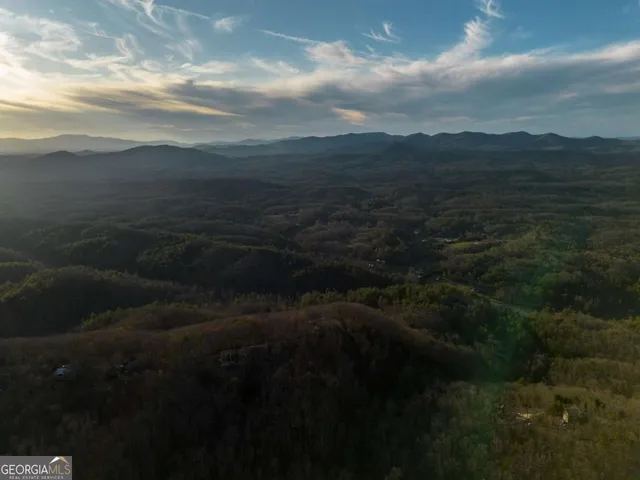 a view of a hallway with a hardwood and a bathroom