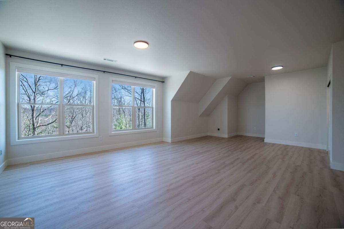 802 Mull Valley Road Morganton, GA 30560 - Photo 29 of 75 an empty room with wooden floor and window