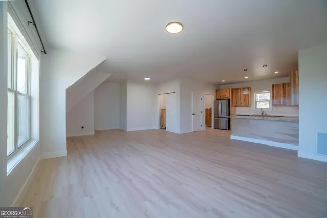 a kitchen with stainless steel appliances granite countertop a stove a sink and a microwave