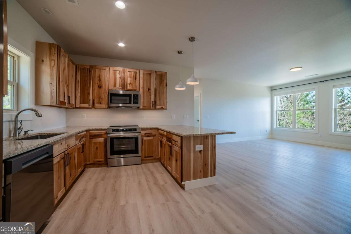 802 Mull Valley Road Morganton, GA 30560 - Photo 6 of 75 a kitchen with stainless steel appliances granite countertop a stove a sink and a microwave