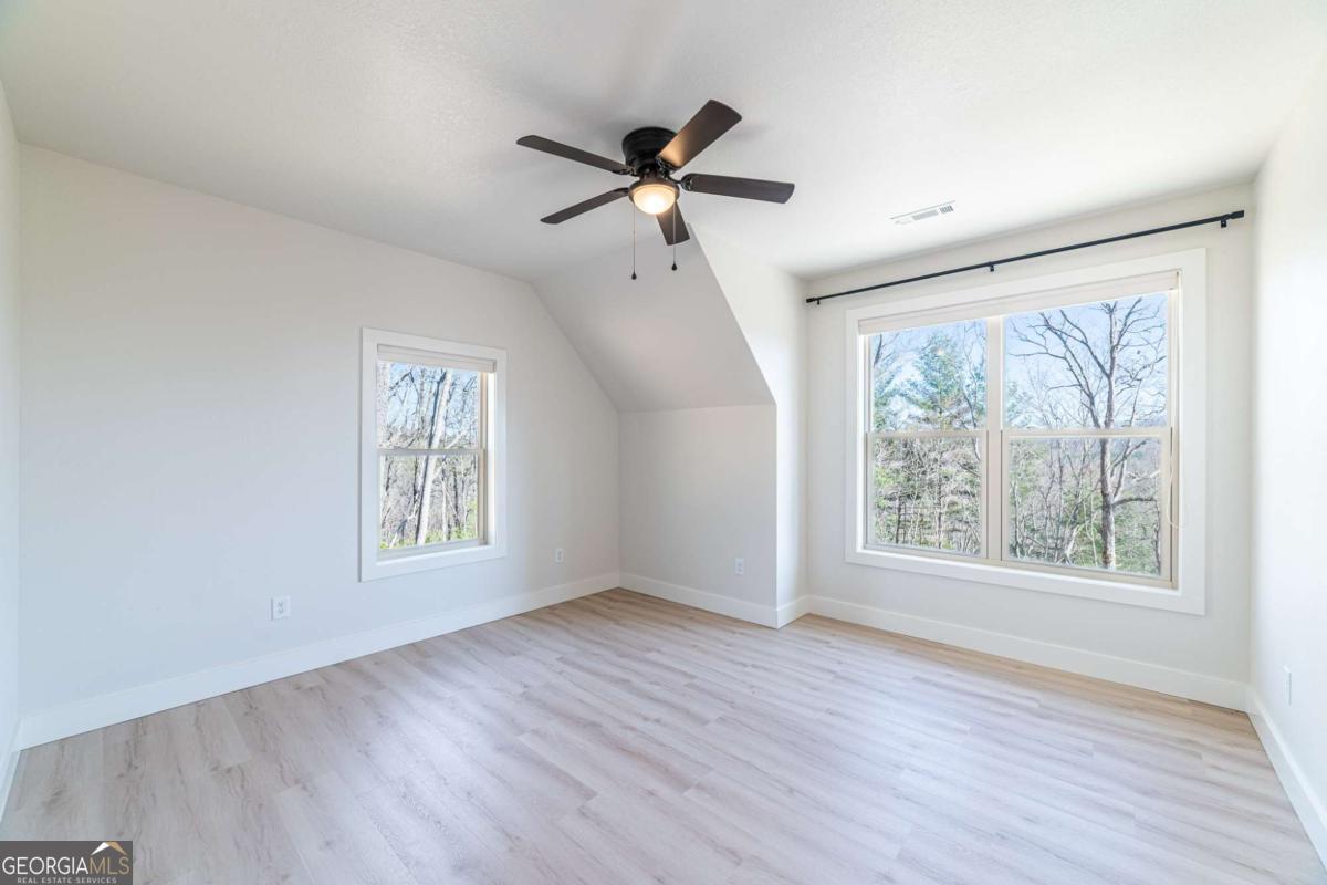 802 Mull Valley Road Morganton, GA 30560 - Photo 10 of 75 a view of empty room with wooden floor and fan