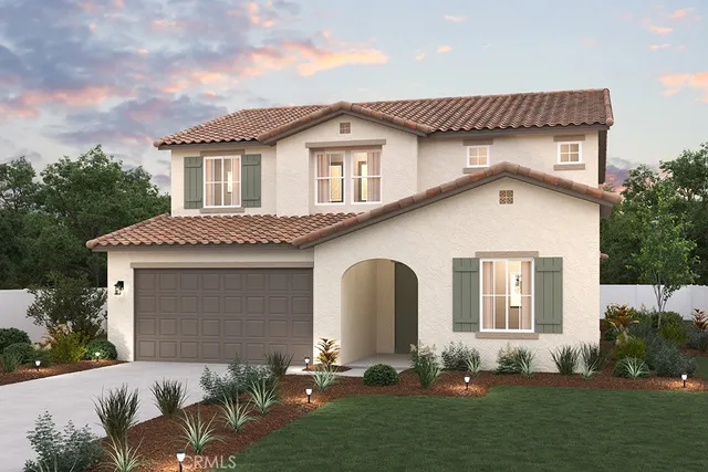 a front view of a house with a garden and plants