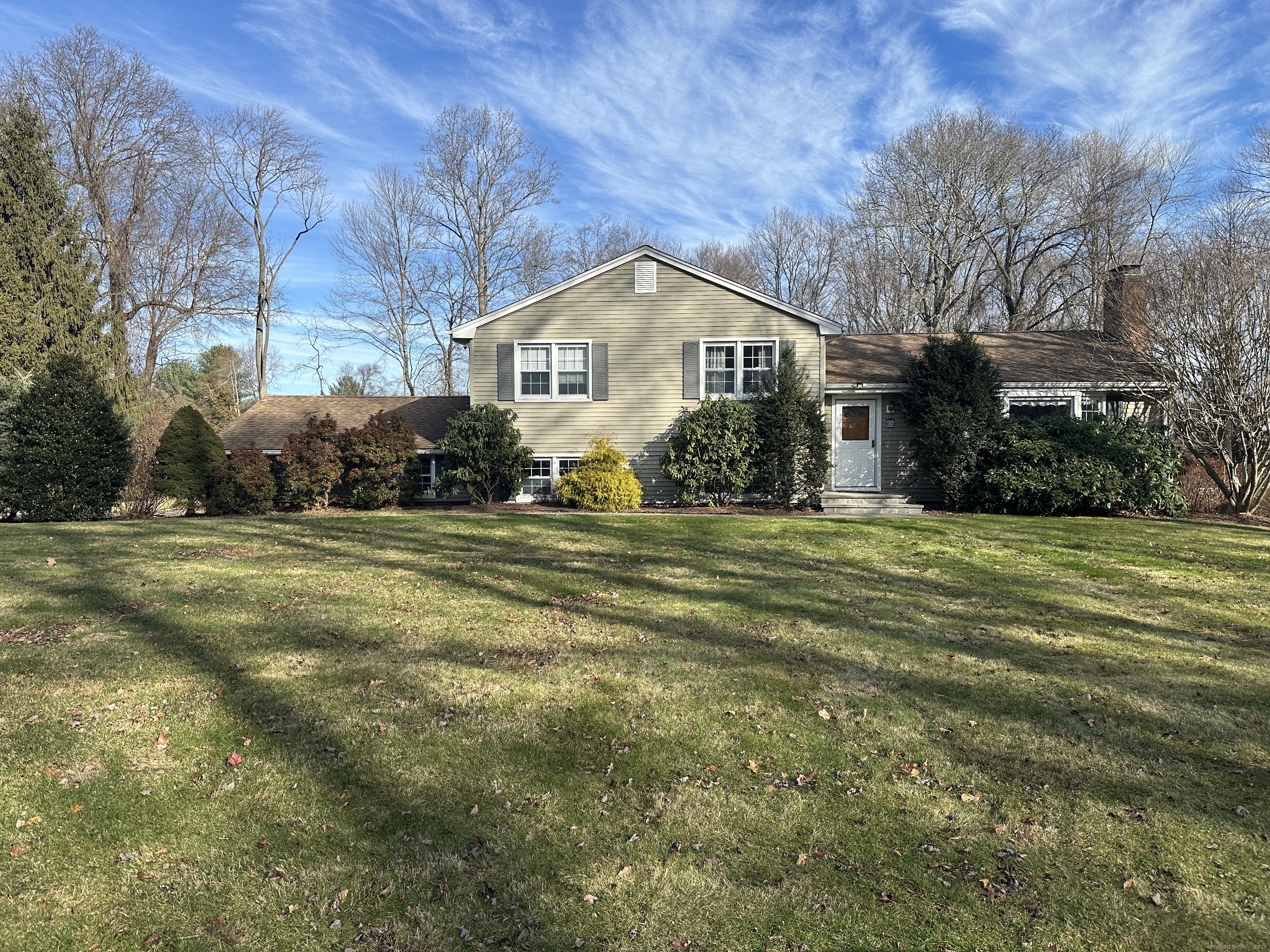 a front view of house with yard and green space