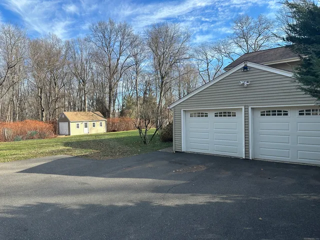 a view of a house with a yard and garage
