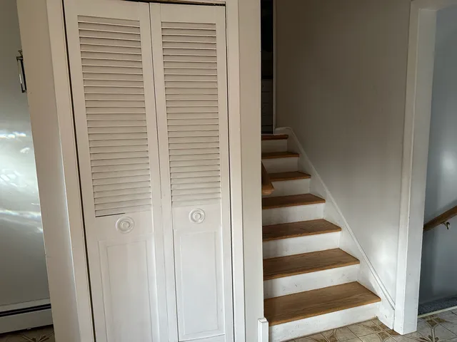 a view of staircase with white walls and a window