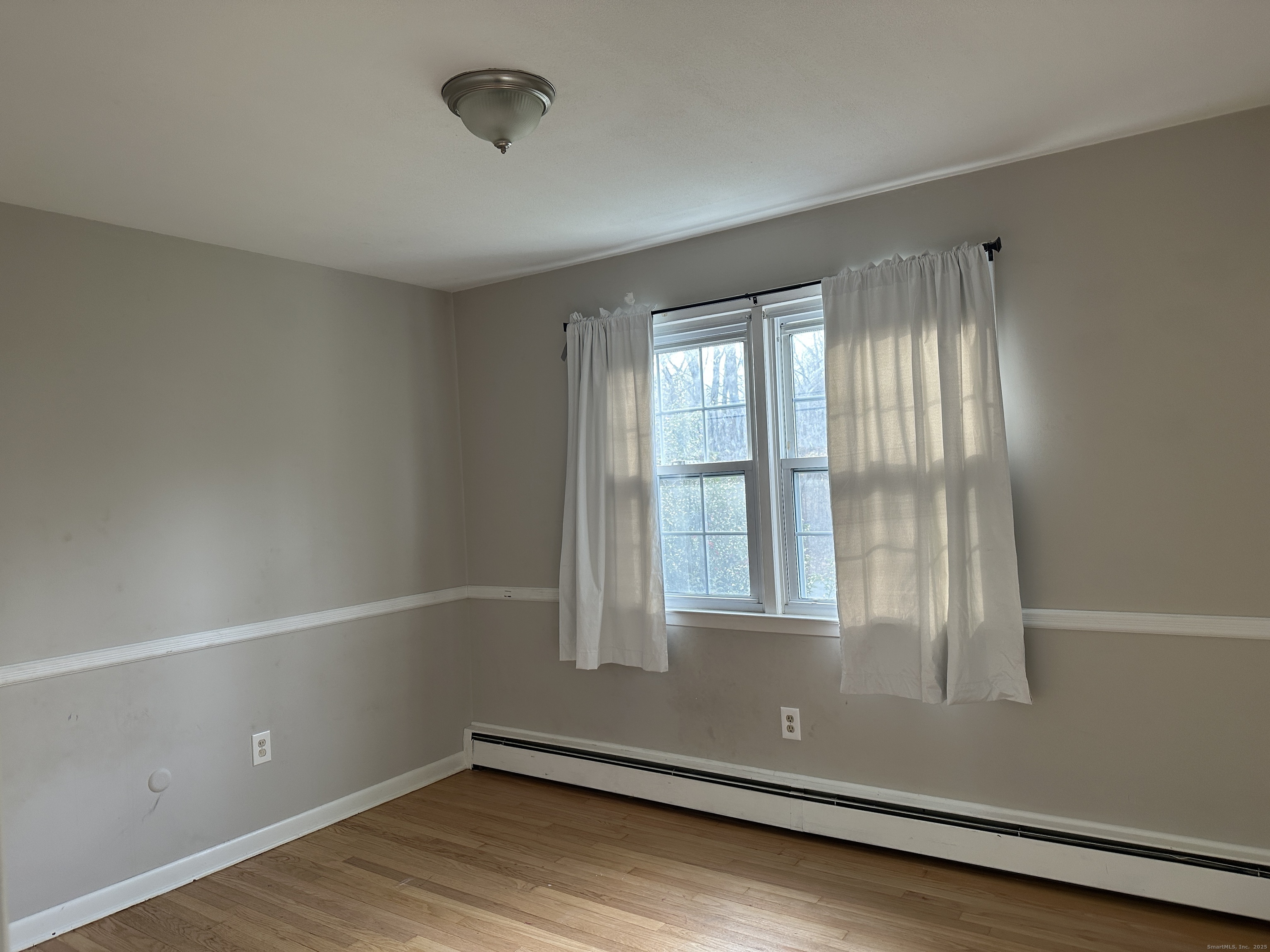 65 Gate Ridge Road Easton, CT 06612 - Photo 8 of 15 an empty room with wooden floor and windows