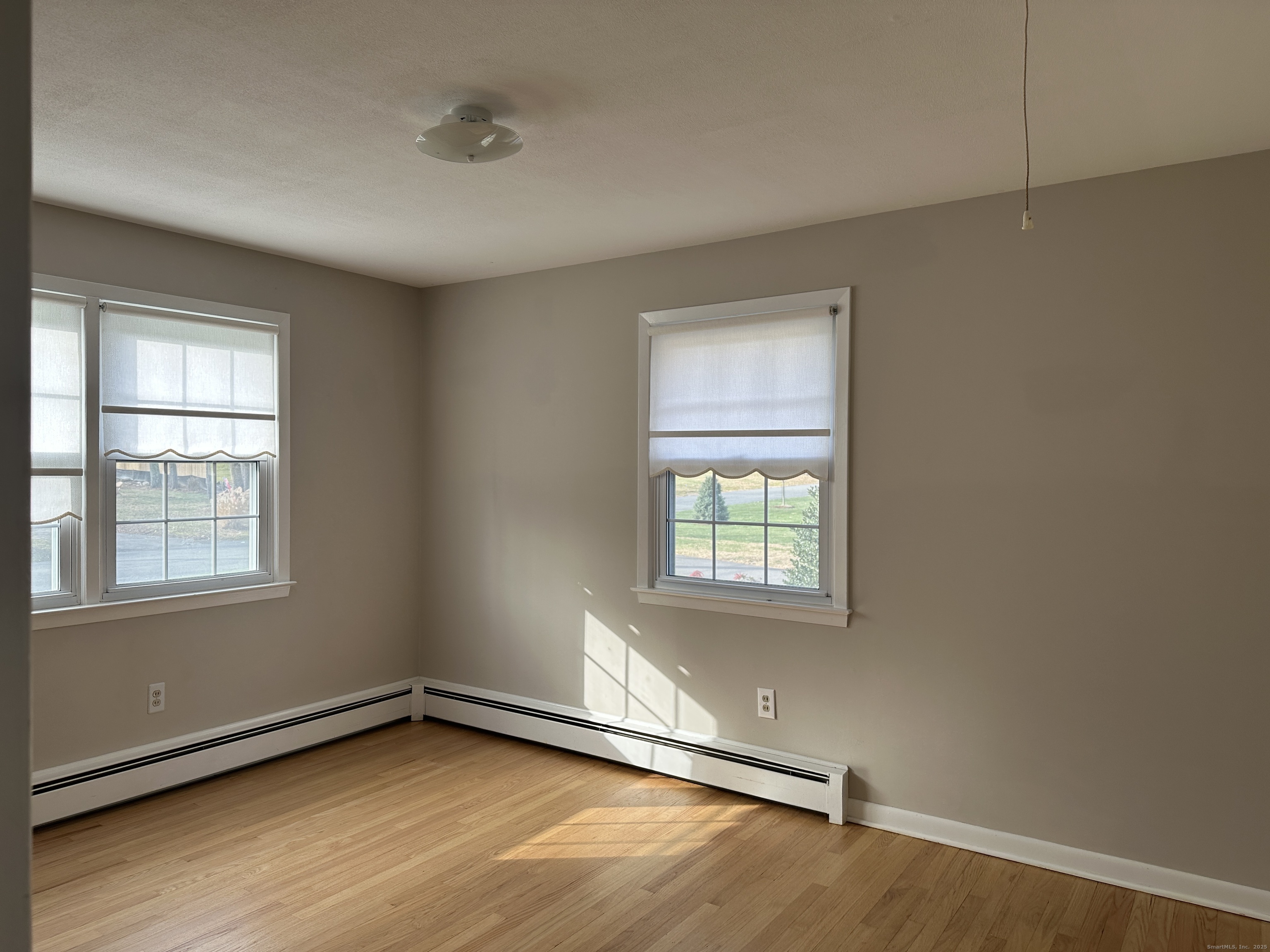 65 Gate Ridge Road Easton, CT 06612 - Photo 9 of 15 an empty room with wooden floor and windows