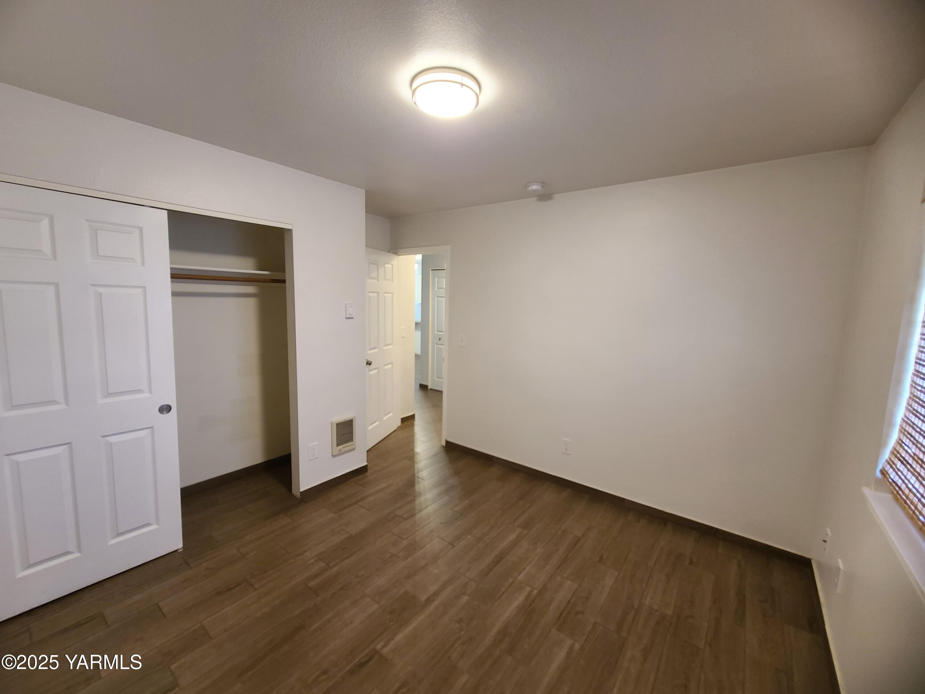 9509 Meadowbrook Road Yakima, WA 98903 - Photo 12 of 14 a view of an empty room with wooden floor