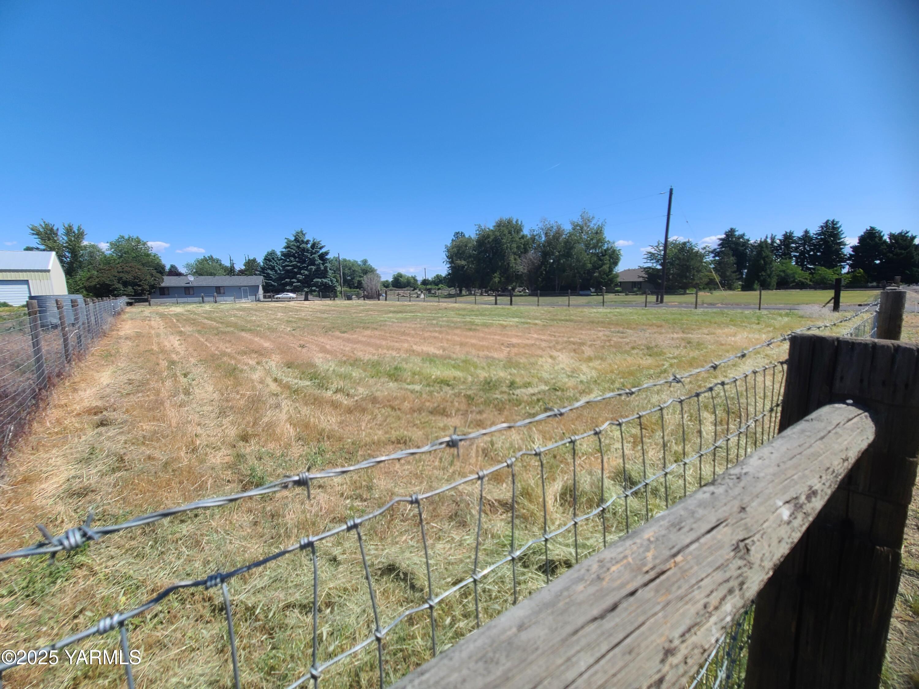 9509 Meadowbrook Road Yakima, WA 98903 - Photo 3 of 14 a view of deck and lake with trees in the background