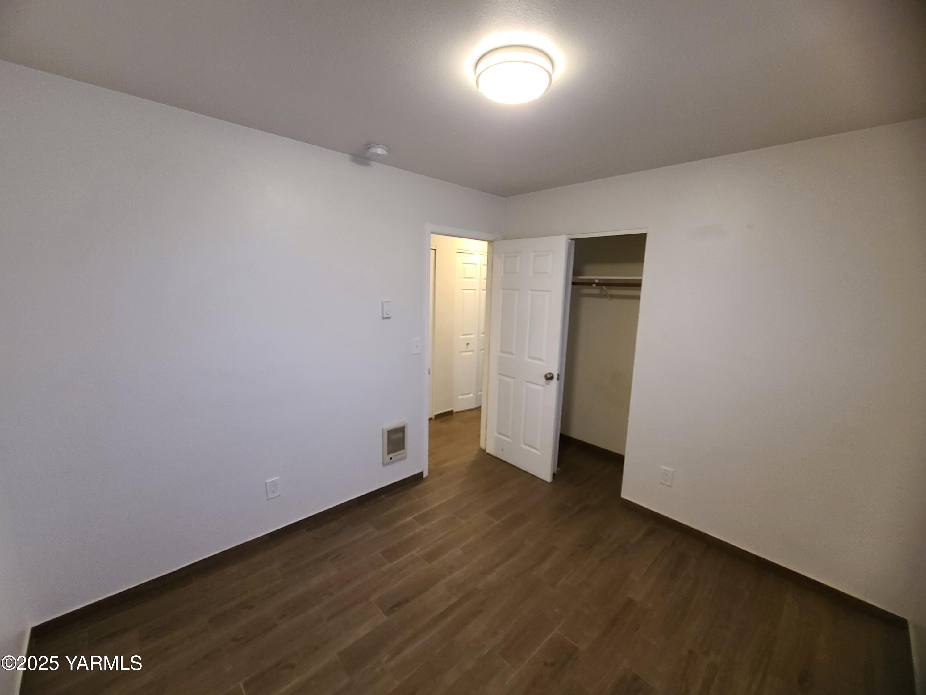 9509 Meadowbrook Road Yakima, WA 98903 - Photo 9 of 14 an empty room with wooden floor and windows