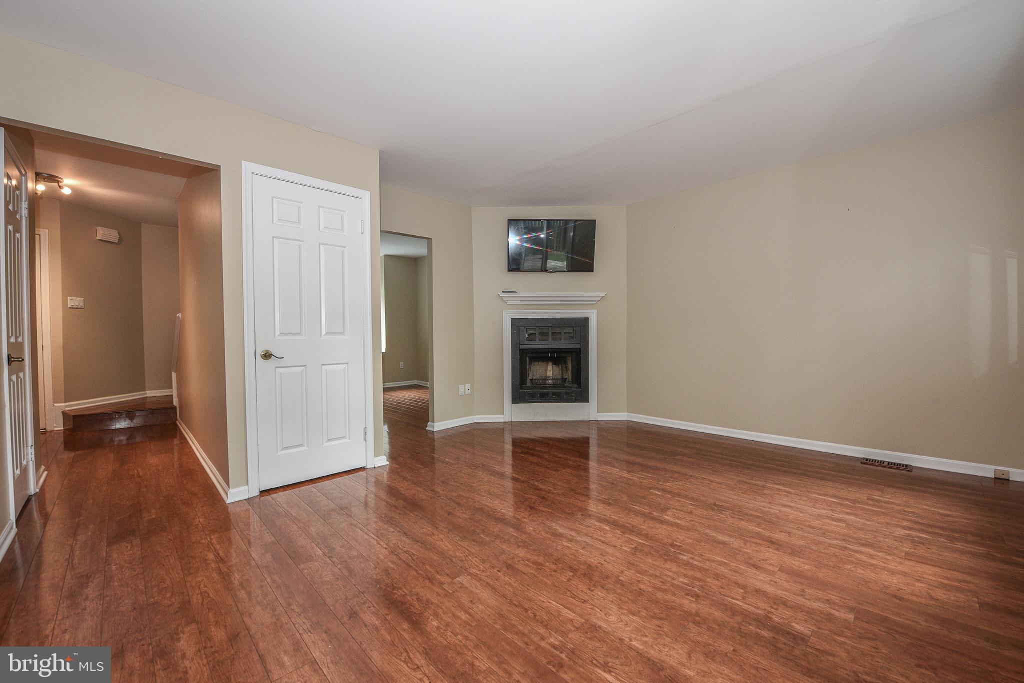 429 Eagle Road Wayne, PA 19087 - Photo 13 of 41 an empty room with wooden floor and fireplace