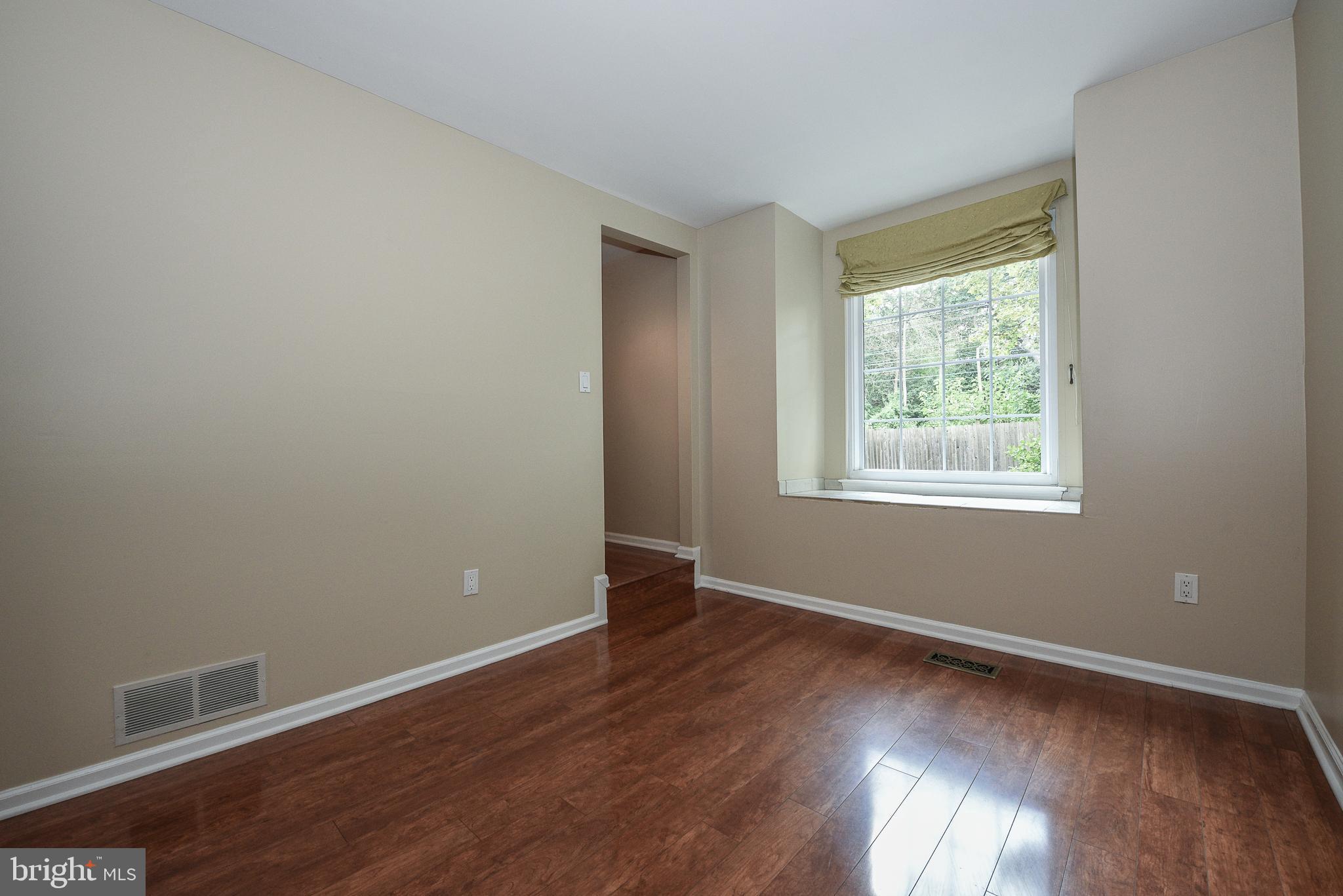 429 Eagle Road Wayne, PA 19087 - Photo 16 of 41 a view of an empty room with wooden floor and a window