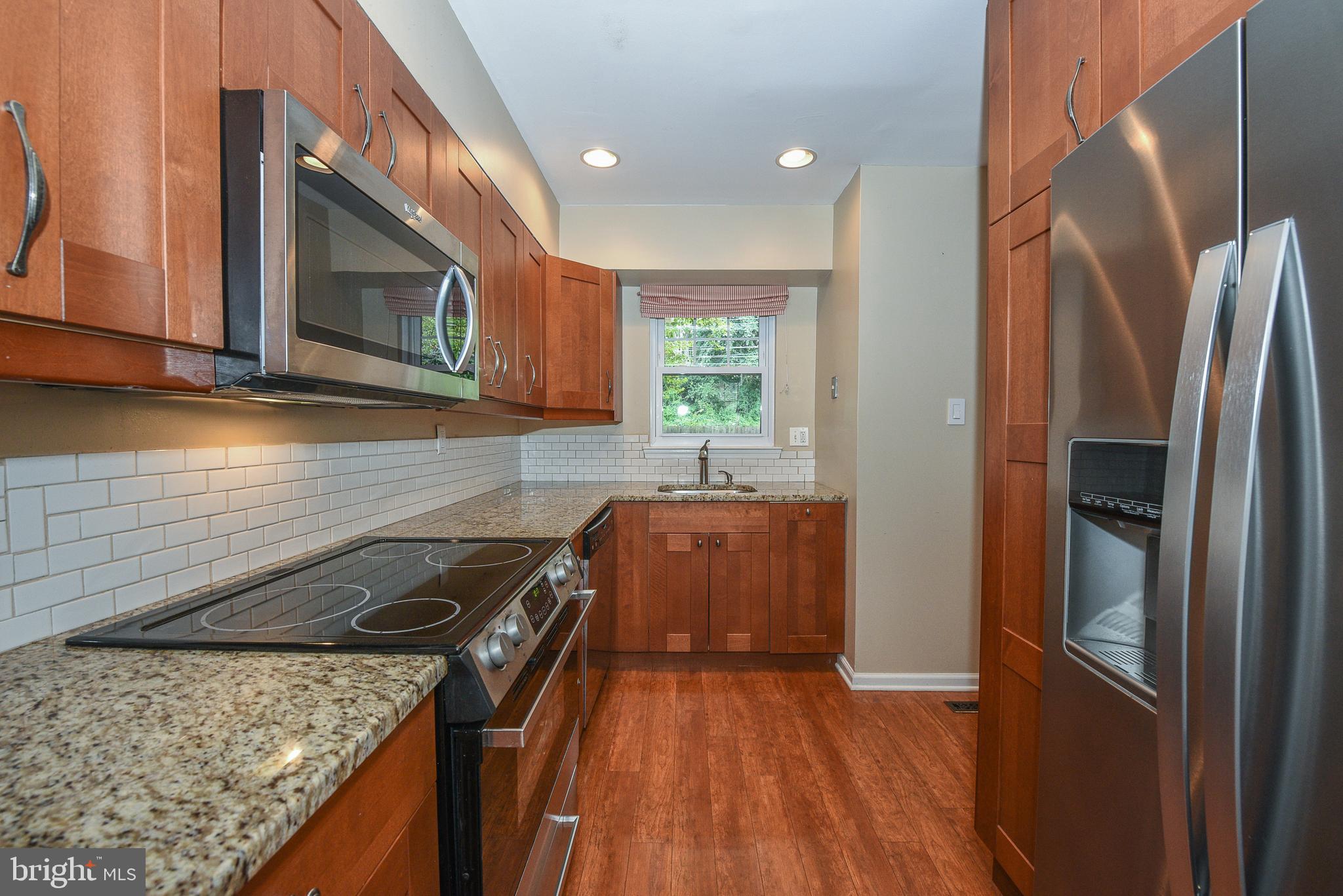 429 Eagle Road Wayne, PA 19087 - Photo 7 of 41 a kitchen with a sink stove and refrigerator