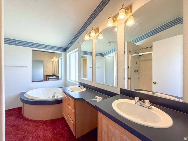 141 South 100 East Emery, UT 84522 - Photo 6 of 17 Dual vanity with integrated sinks, wood-finish cabinetry, built-in soaking tub, and enclosed shower with glass door