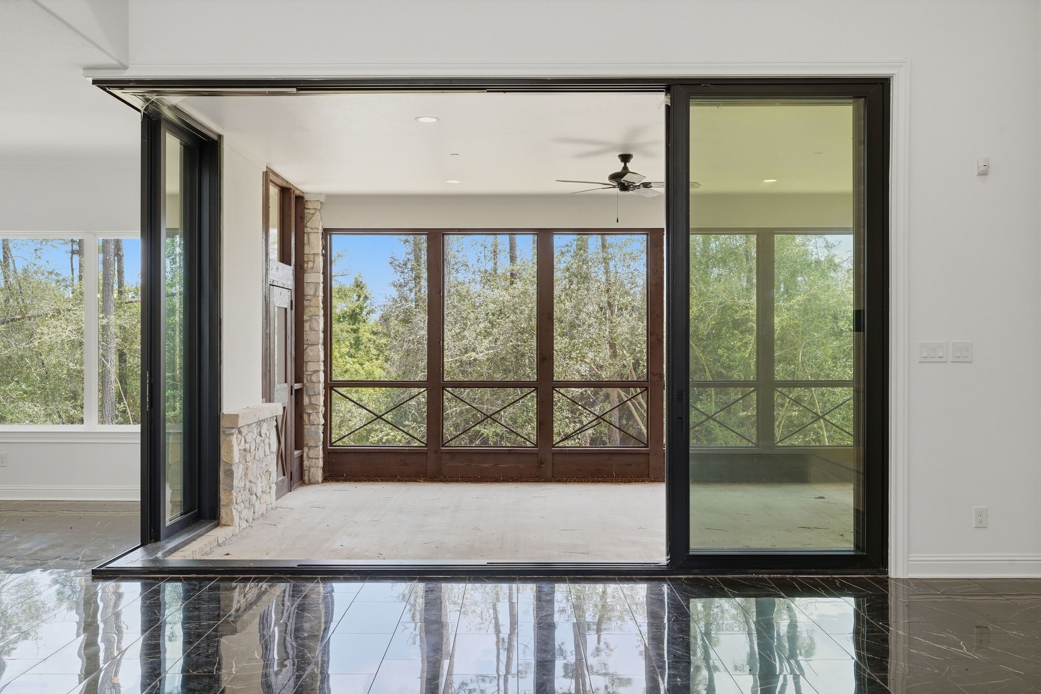 16081 Forest Mill Road Willis, TX 77378 - Photo 9 of 37 The screened porch extends the living space and offers peaceful views of the surrounding wooded acreage.