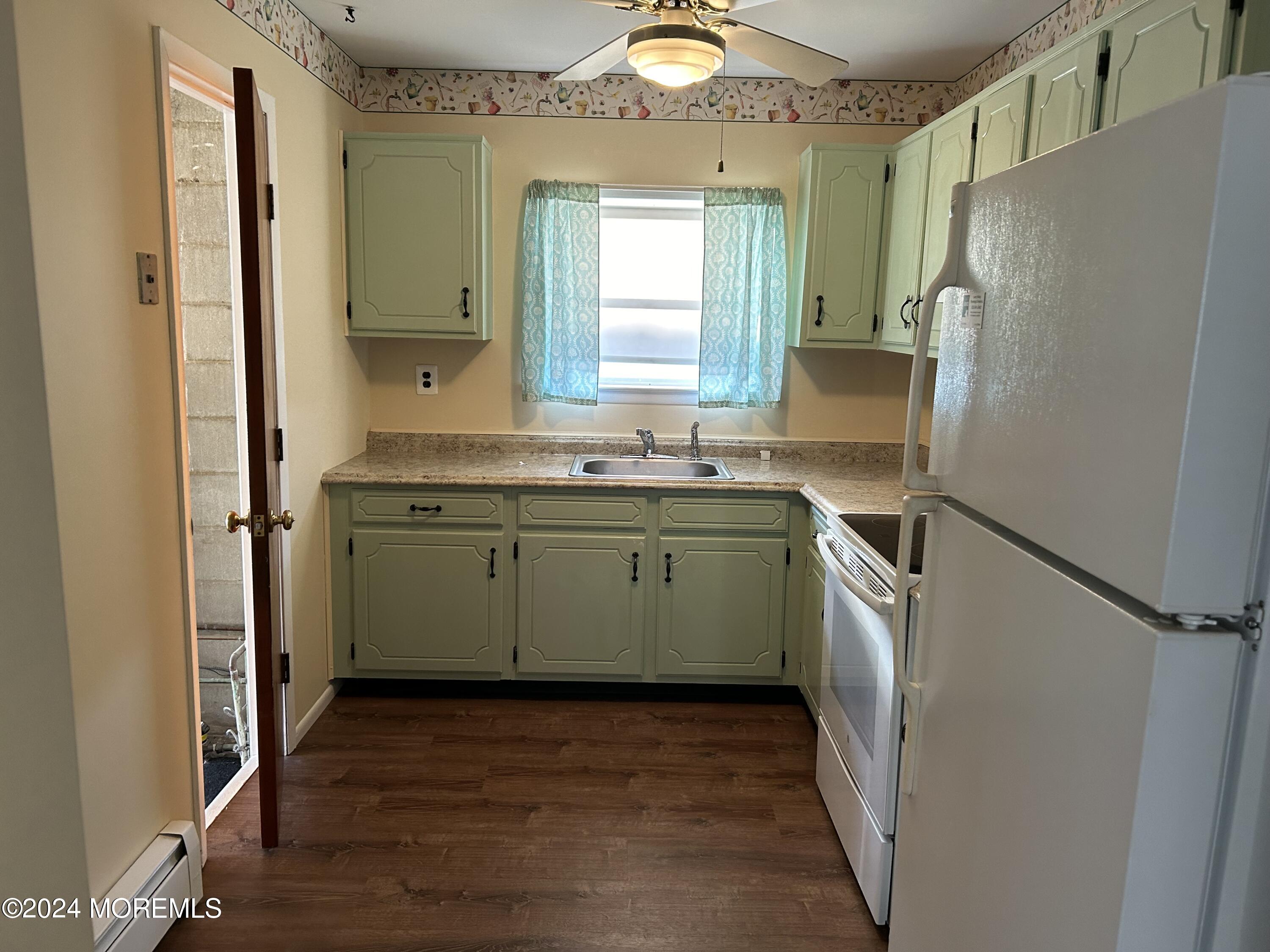 38 Eldorado Street Toms River, NJ 08757 - Photo 4 of 11 a kitchen with a sink a refrigerator and window